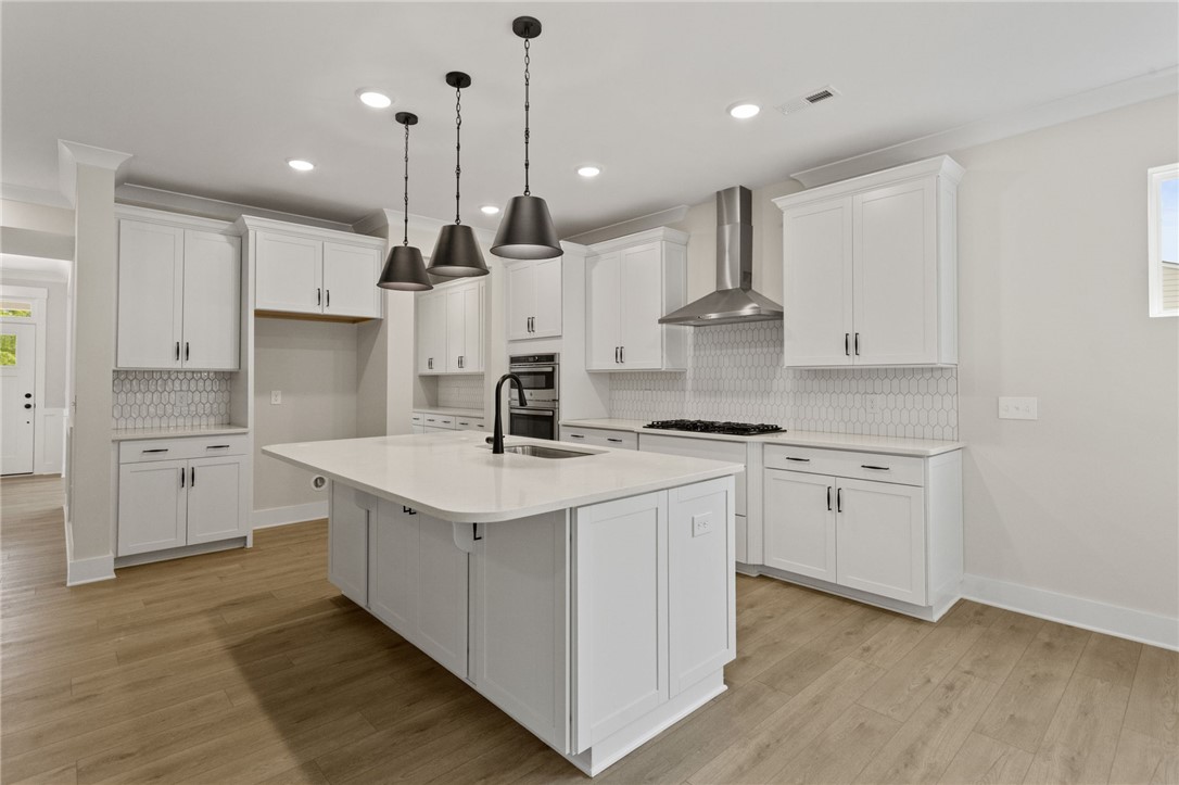 313 Old Shirley Road Central, SC 29630 - Photo 5 of 30 This bright, modern kitchen features sleek countertops and ample cabinetry, ideal for culinary creativity.