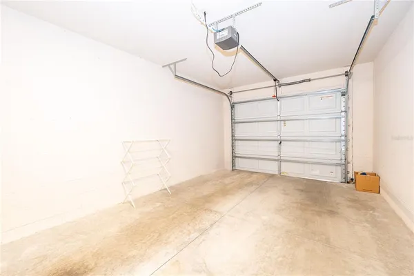 a view of a patio with table and chairs and floor to ceiling window