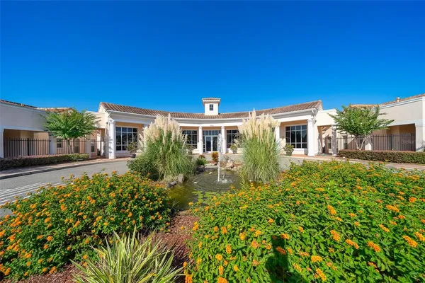 a living room with furniture kitchen view and a flat screen tv