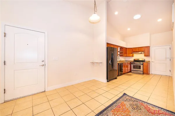 a kitchen with stainless steel appliances a stove top oven and cabinets