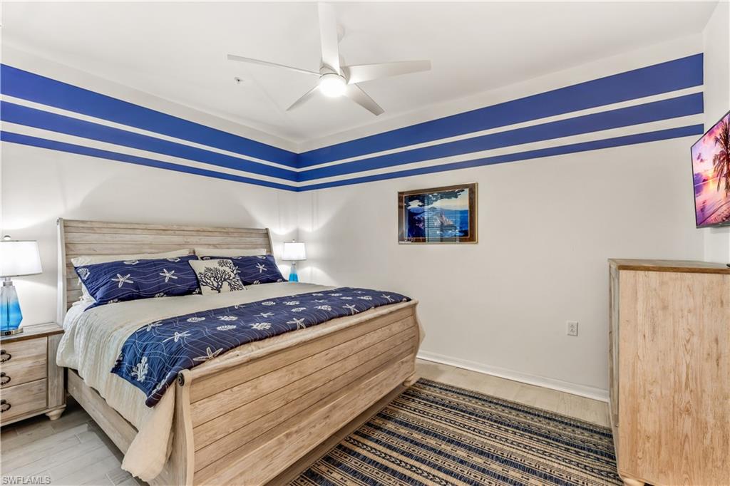 43989 Boardwalk Loop, Unit 2042 Babcock Ranch, FL 33982 - Photo 9 of 12 a bedroom with a bed and a ceiling fan