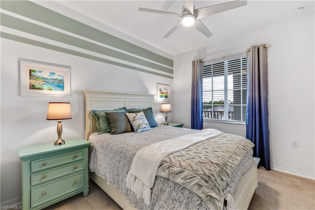 43989 Boardwalk Loop, Unit 2042 Babcock Ranch, FL 33982 - Photo 10 of 12 a bedroom with a bed and a night stand