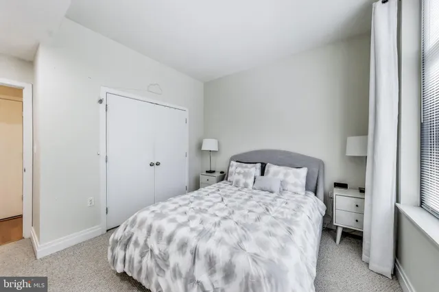 a bedroom with a bed and a mirror