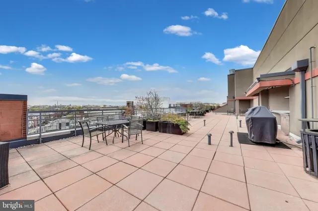 a view of a terrace with furniture and a stove
