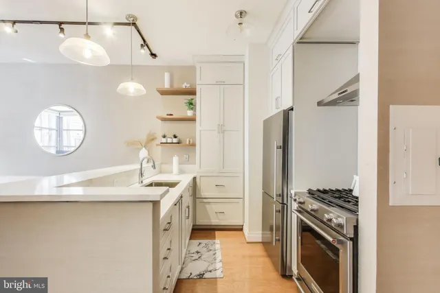 a kitchen with a sink appliances and cabinets
