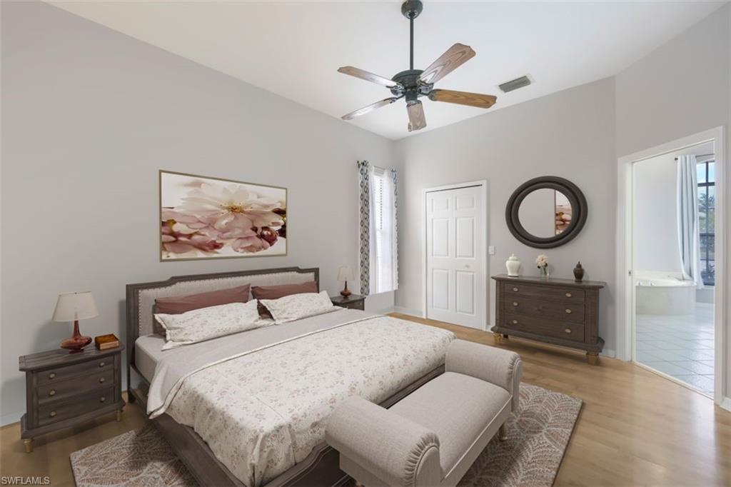 496 Raven Way Naples, FL 34110 - Photo 13 of 31 a bedroom with a bed and a chandelier