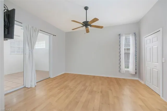 a view of empty room with ceiling fan