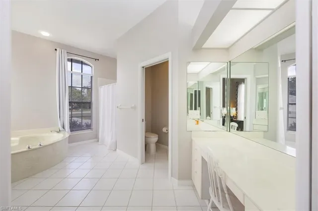 a bathroom with a tub shower and sink