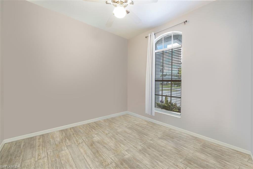 496 Raven Way Naples, FL 34110 - Photo 22 of 31 a view of an empty room with a window