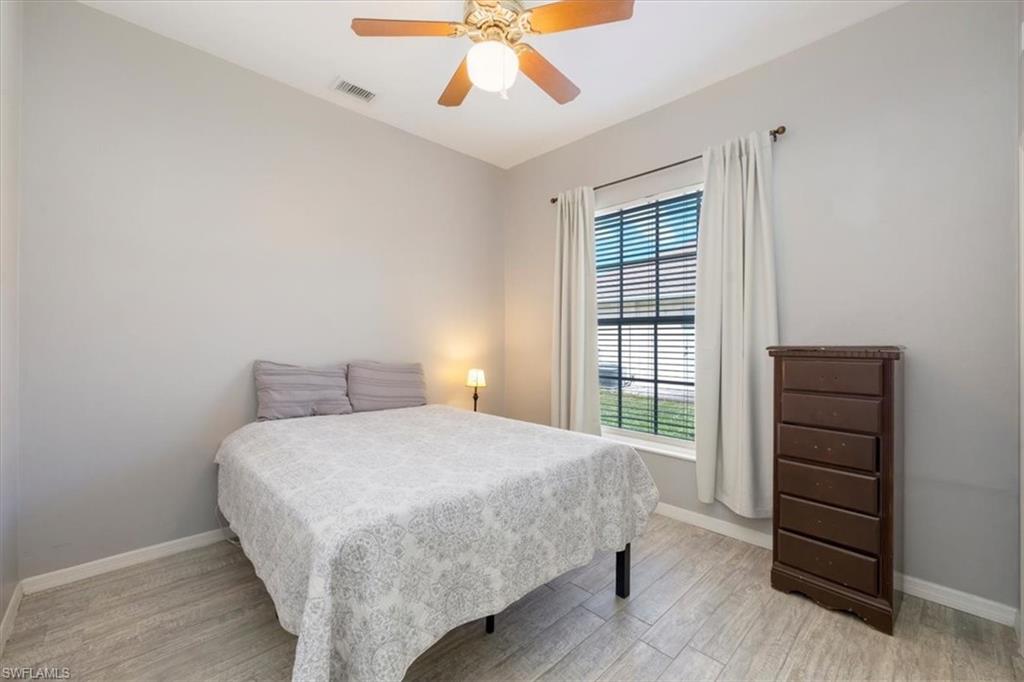 496 Raven Way Naples, FL 34110 - Photo 23 of 31 a bedroom with a bed and a window
