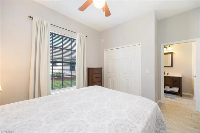 a bedroom with a bed and a large window