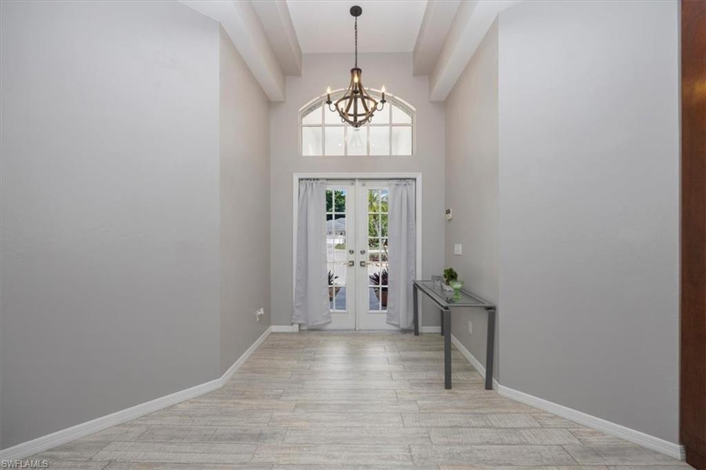 496 Raven Way Naples, FL 34110 - Photo 3 of 31 a view of an entryway with wooden floor