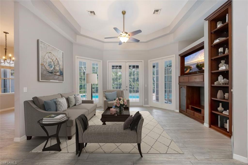 496 Raven Way Naples, FL 34110 - Photo 4 of 31 a living room with fireplace furniture and a large window