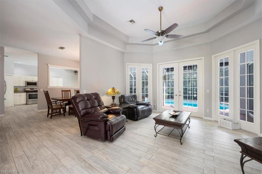 496 Raven Way Naples, FL 34110 - Photo 6 of 31 a living room with furniture and a large window