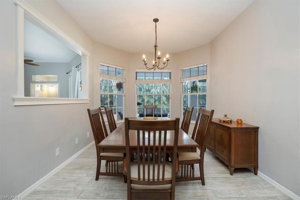 496 Raven Way Naples, FL 34110 - Photo 8 of 31 a view of a dining room with furniture window and outside view