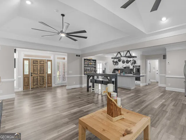 a spacious bedroom with a bed and a ceiling fan