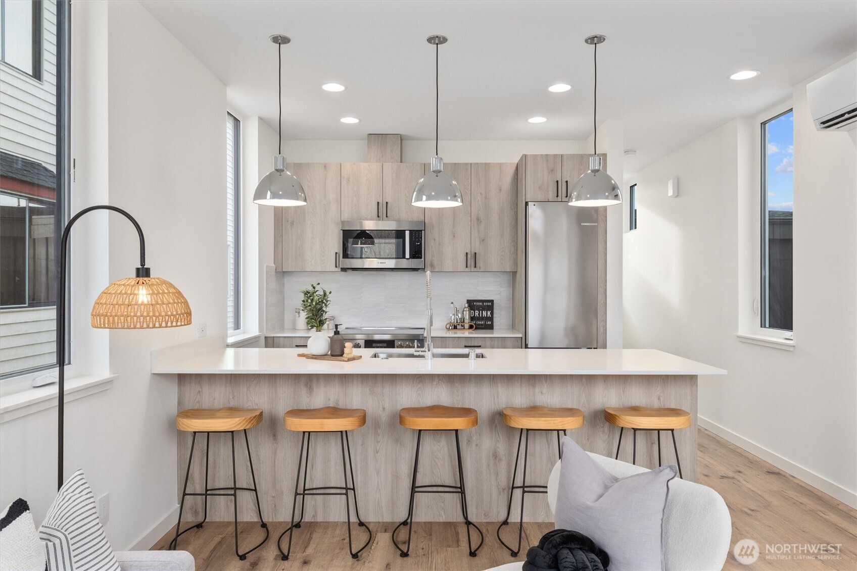 945 Northwest 61st Street Seattle, WA 98107 - Photo 12 of 24 a kitchen with stainless steel appliances granite countertop a sink a stove a refrigerator and island with wooden floor