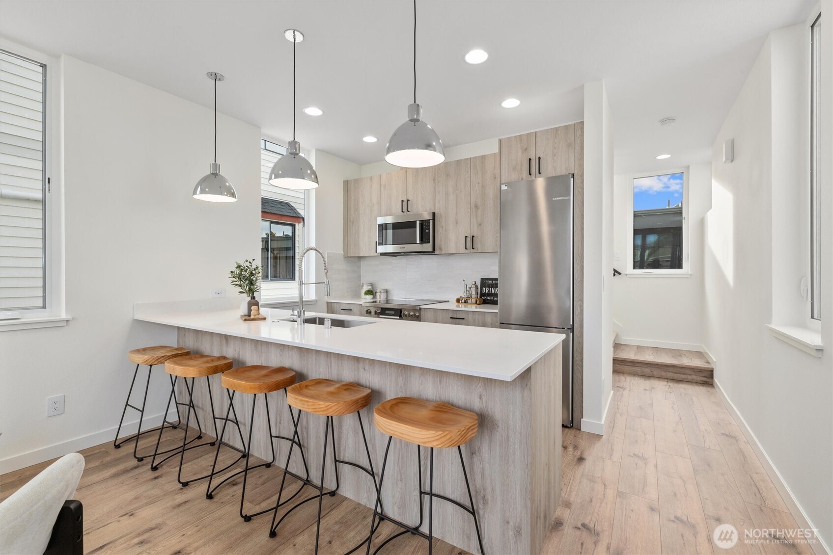 945 Northwest 61st Street Seattle, WA 98107 - Photo 9 of 24 a large kitchen with a table and chairs in it