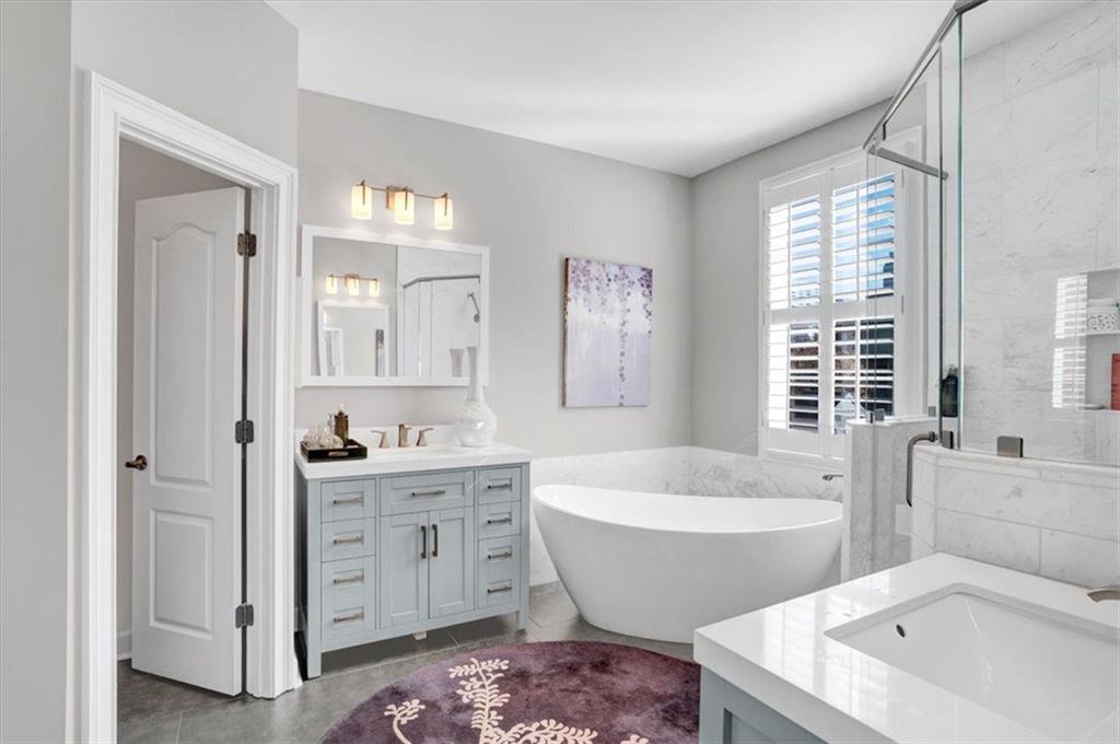 188 Centennial Way Atlanta, GA 30313 - Photo 20 of 30 a spacious bathroom with a bathtub a double vanity sink a window and mirror