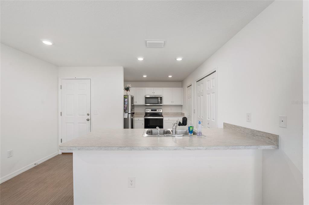 4400 Southwest 155th Street Ocala, FL 34473 - Photo 19 of 41 a kitchen with stainless steel appliances a refrigerator and a stove top oven