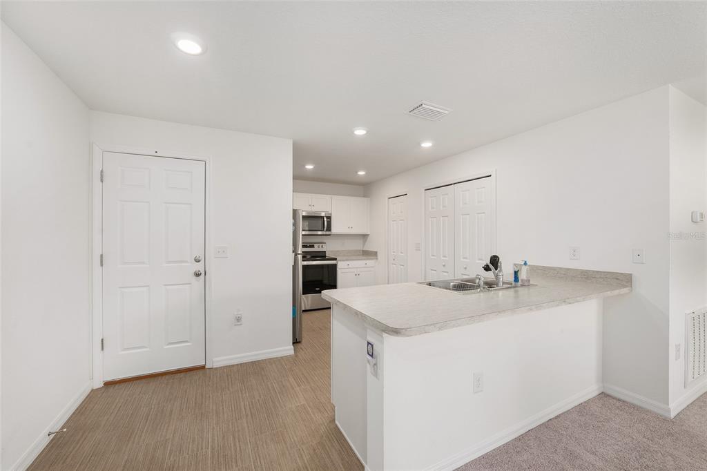 4400 Southwest 155th Street Ocala, FL 34473 - Photo 20 of 41 a kitchen with kitchen island a sink appliances and cabinets