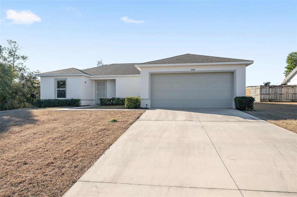 4400 Southwest 155th Street Ocala, FL 34473 - Photo 2 of 41 a front view of a house with a yard