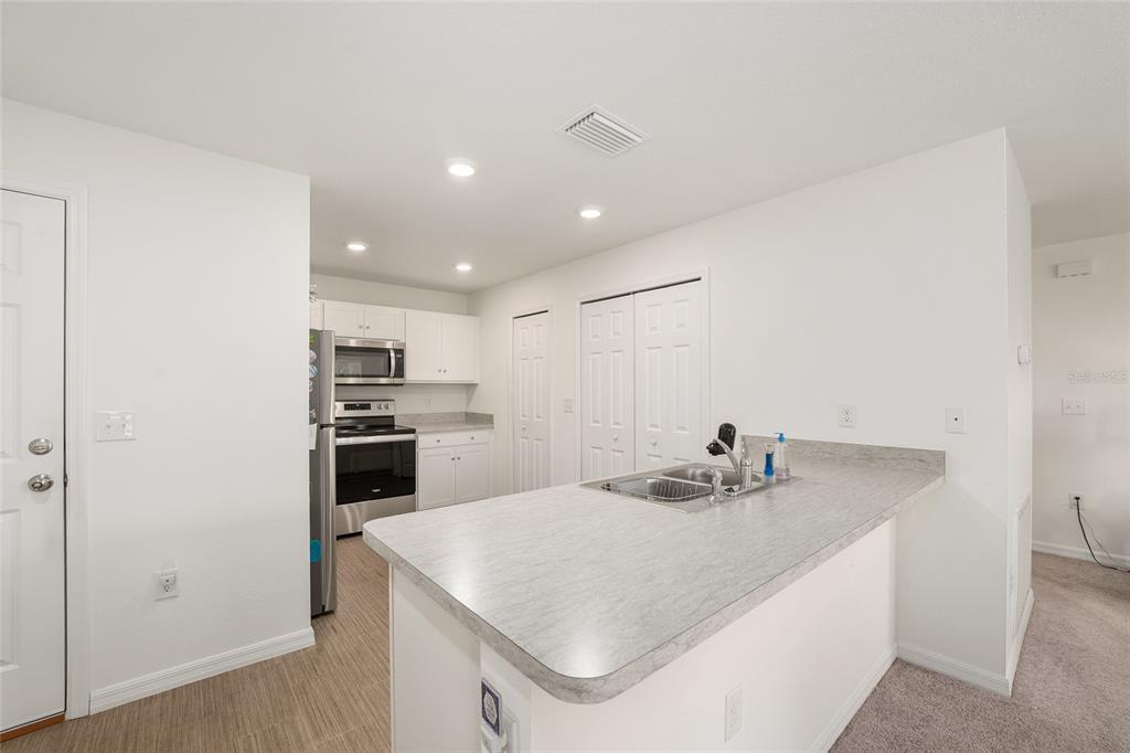 4400 Southwest 155th Street Ocala, FL 34473 - Photo 21 of 41 a kitchen with kitchen island a sink stainless steel appliances and cabinets