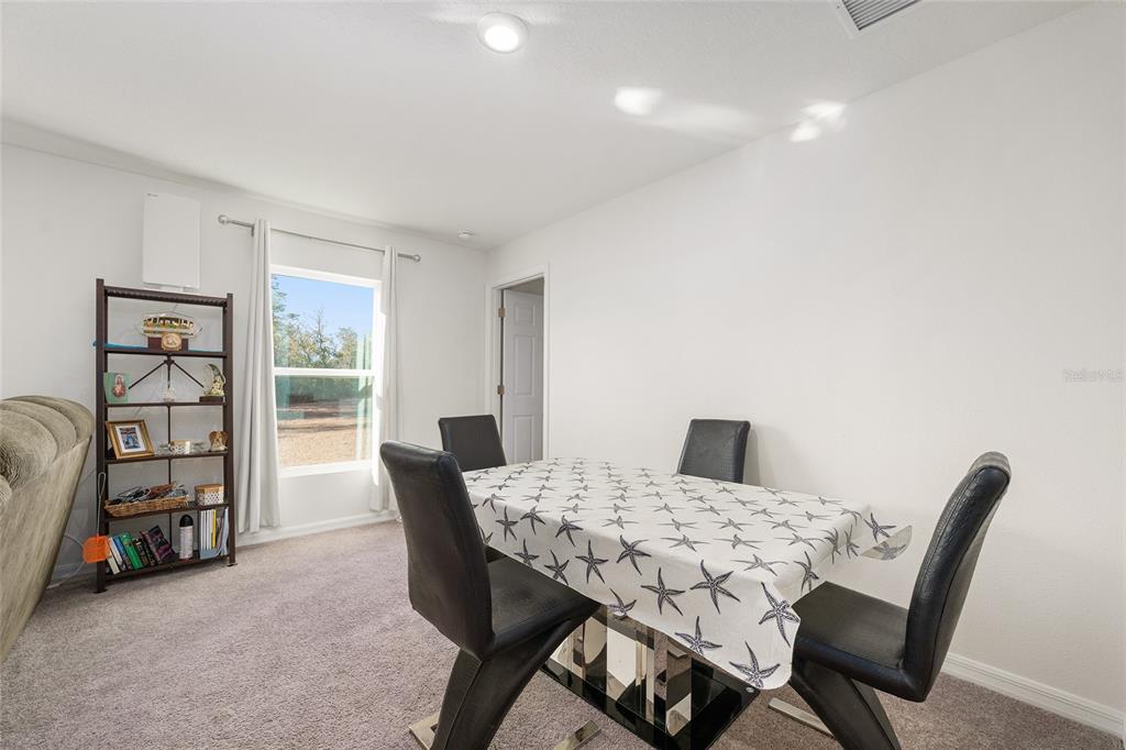 4400 Southwest 155th Street Ocala, FL 34473 - Photo 26 of 41 a view of a dining room with furniture and window