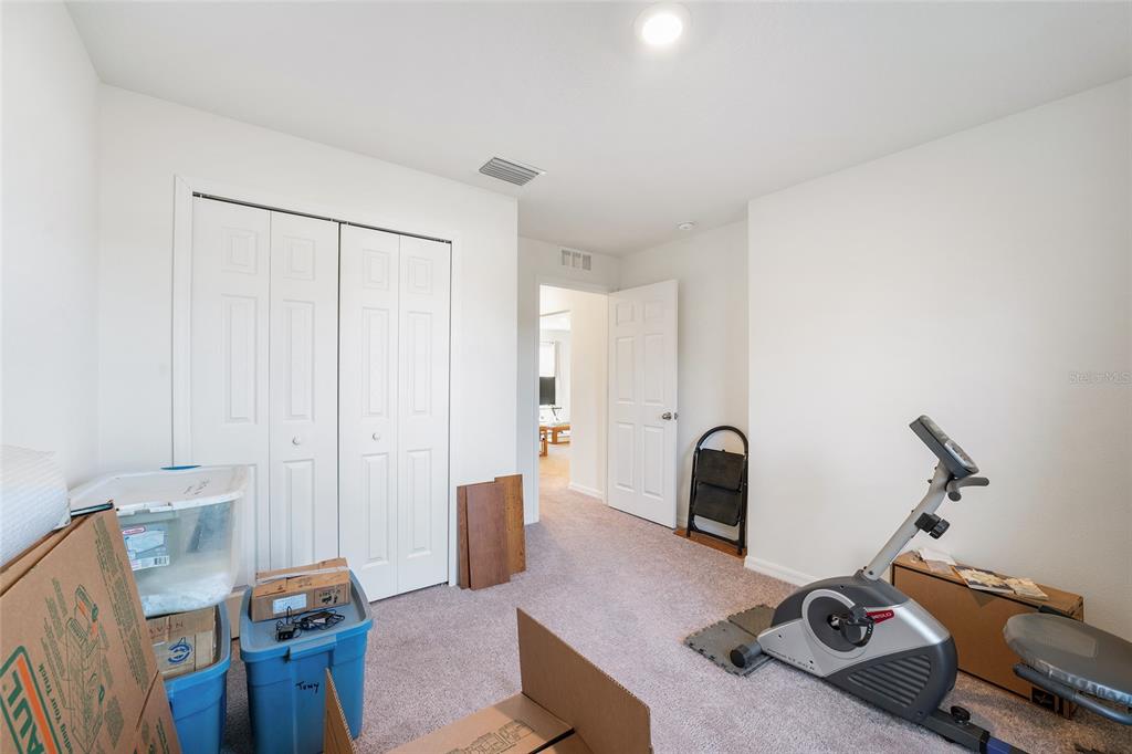 4400 Southwest 155th Street Ocala, FL 34473 - Photo 32 of 41 a bedroom with furniture and a wooden floor