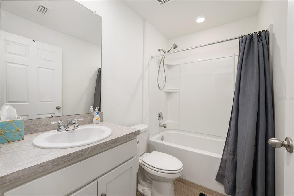 4400 Southwest 155th Street Ocala, FL 34473 - Photo 35 of 41 a bathroom with a granite countertop sink toilet and shower