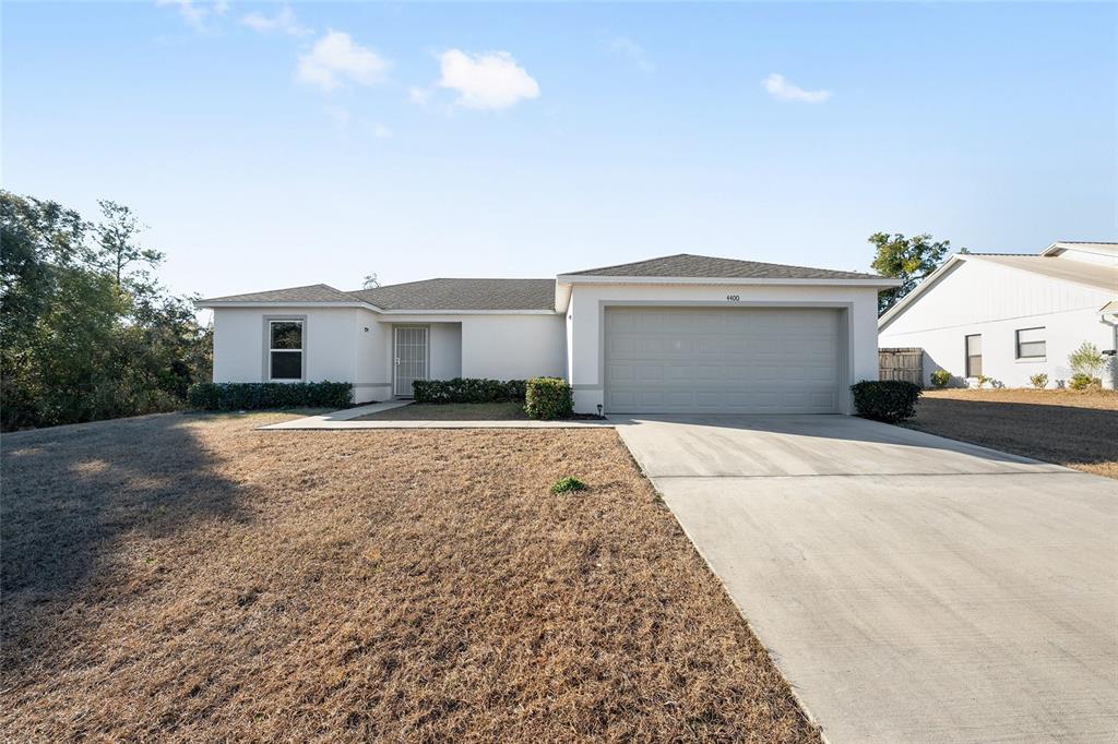 4400 Southwest 155th Street Ocala, FL 34473 - Photo 4 of 41 a front view of a house with a yard and garage