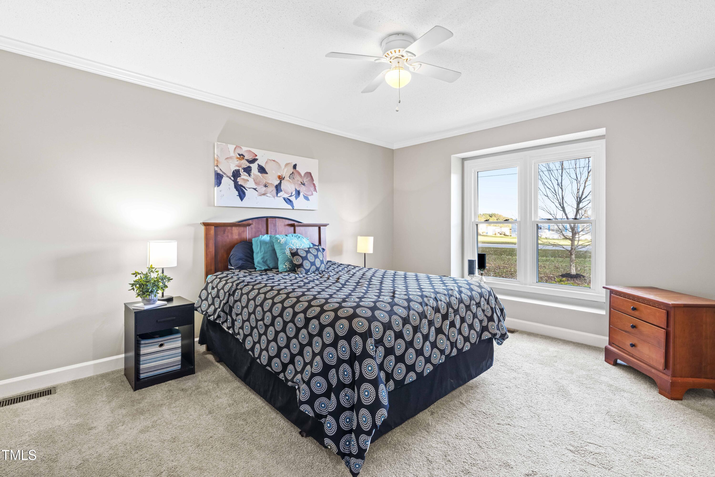 1862 Ranch Road Clayton, NC 27520 - Photo 11 of 26 a bedroom with a bed dresser and a window
