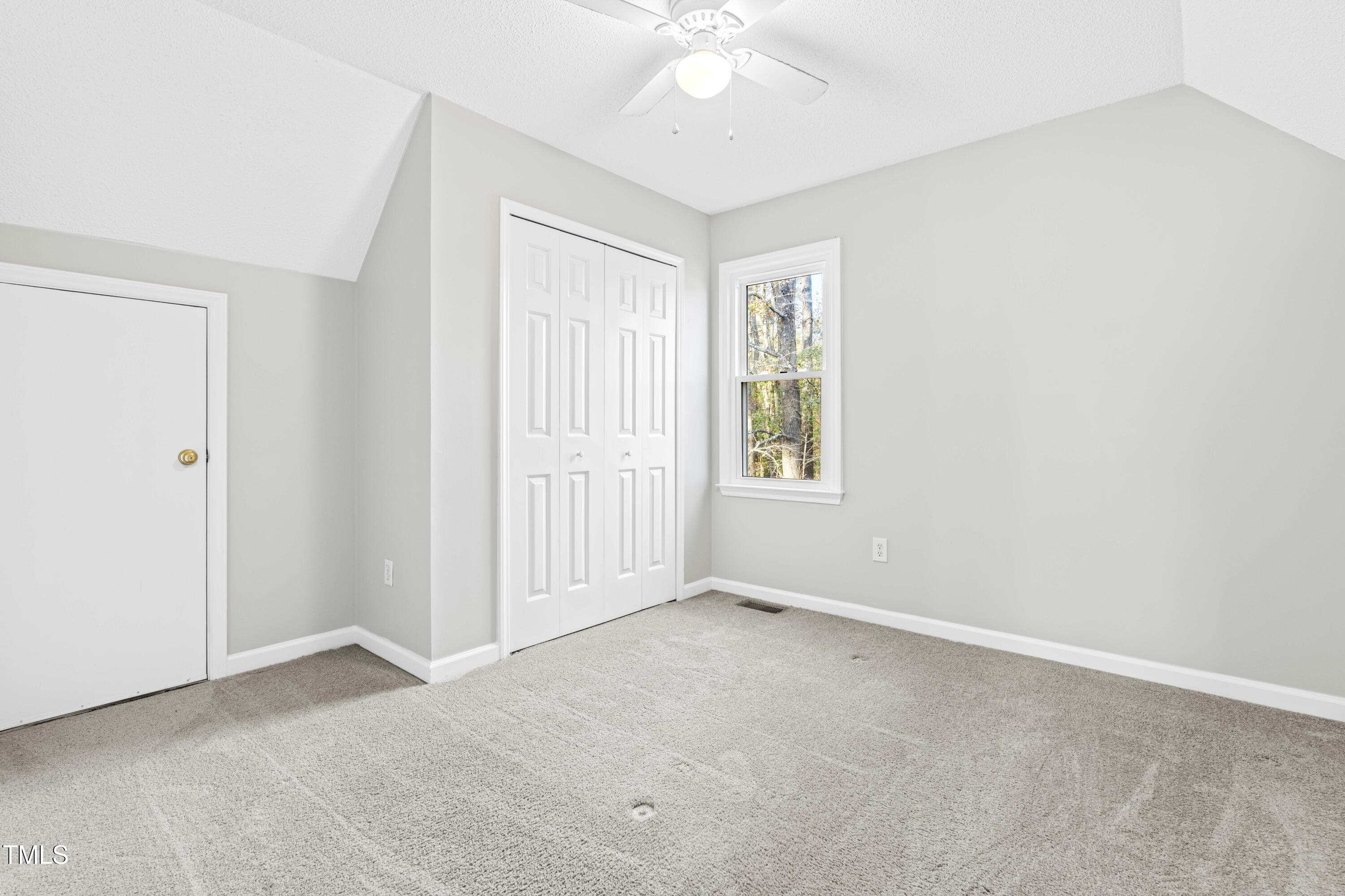 1862 Ranch Road Clayton, NC 27520 - Photo 16 of 26 an empty room with windows and ceiling fan