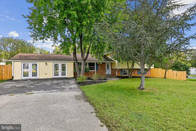 a house with green field in front of it