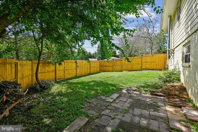 a view of backyard with swimming pool
