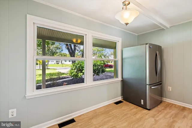 a kitchen with a refrigerator and window