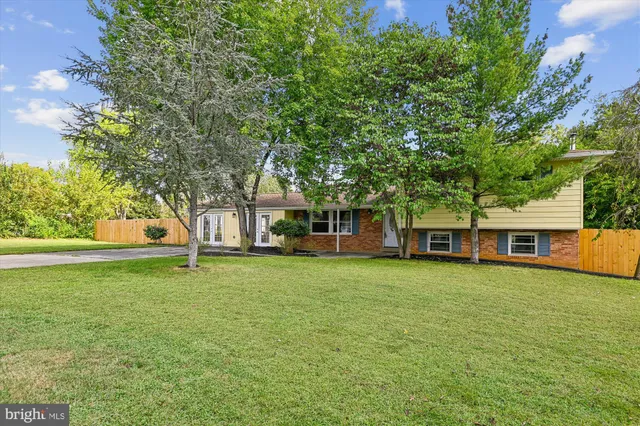 a view of a house with a backyard
