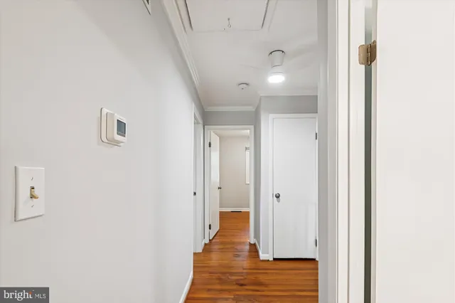 a view of a hallway with wooden floor