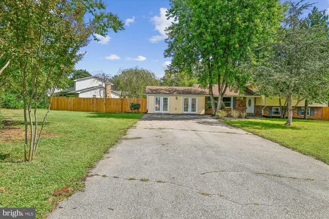 a front view of house with yard and green space