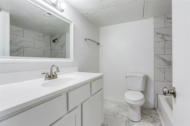 a bathroom with a sink toilet and mirror