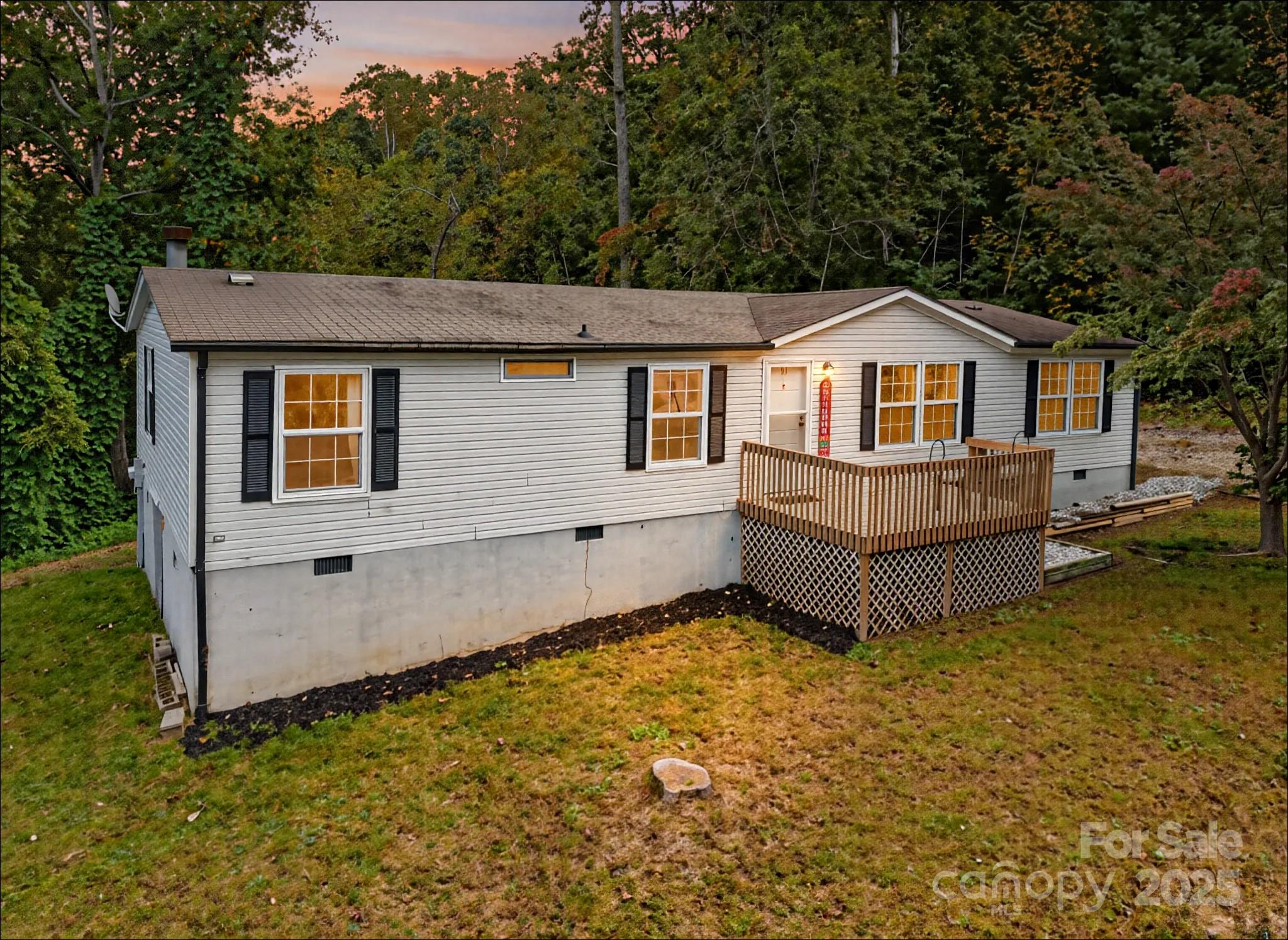 a front view of a house with yard and trees