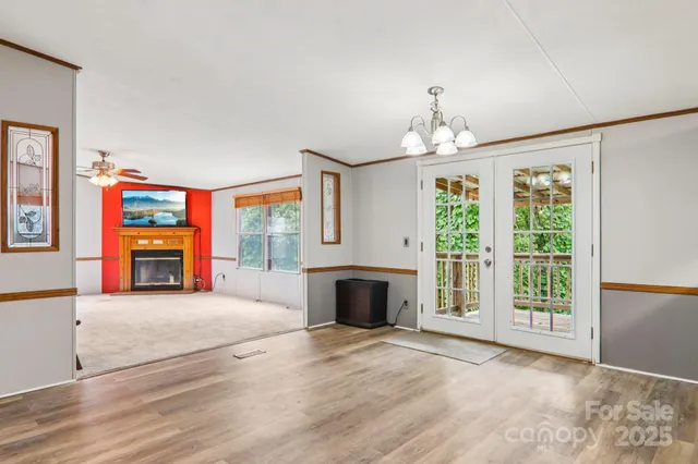 wooden floor fireplace and windows in an empty room