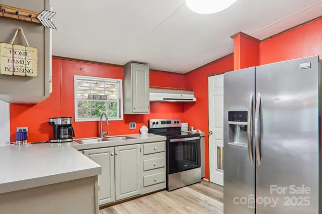 a kitchen with stainless steel appliances a sink and a refrigerator