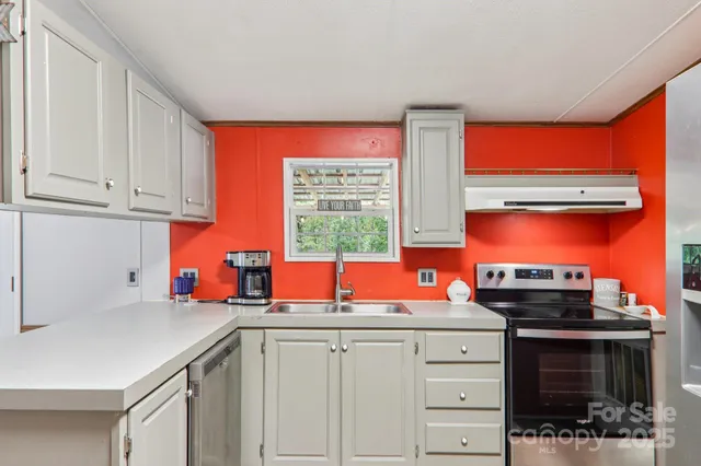 a kitchen with stainless steel appliances a stove sink and cabinets