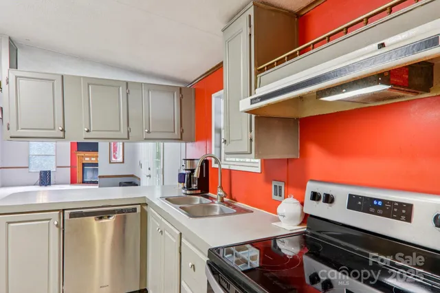a kitchen with stainless steel appliances a sink a stove and a refrigerator