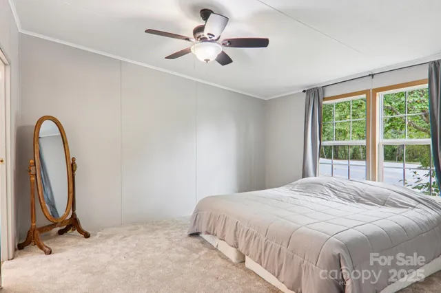 a bedroom with a bed and a large window