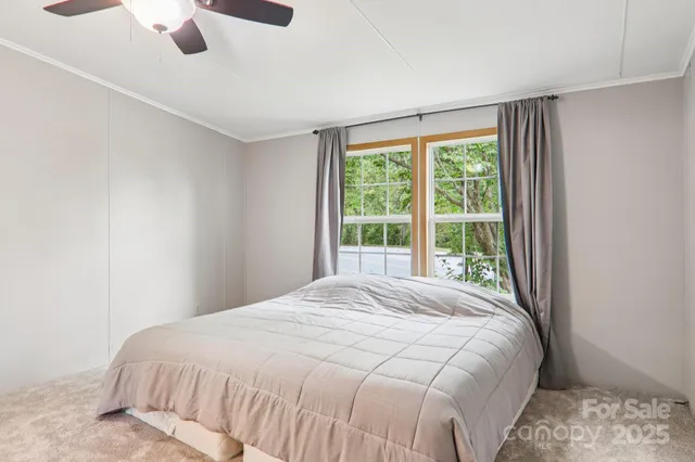 a large bed sitting in a bedroom next to a window