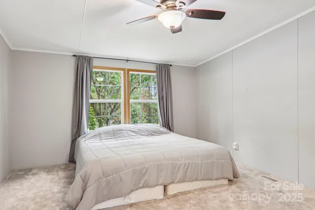 a large bed sitting in a bedroom next to a window