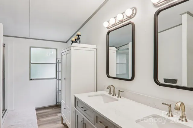 a bathroom with a double vanity sink mirror and