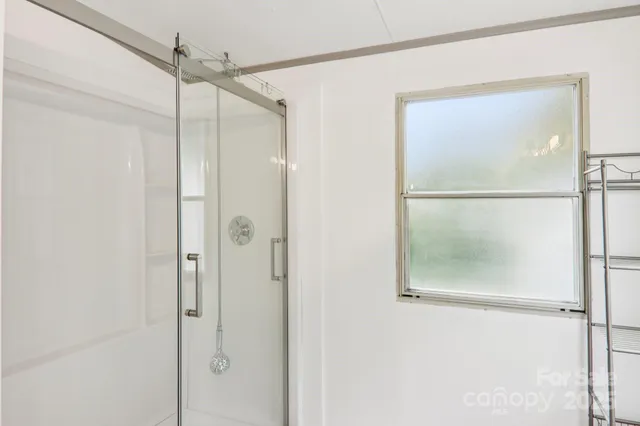 a bathroom with a glass shower door